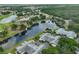 Stunning aerial view showcases the community's serene lake, lush greenery, and well-maintained homes at 815 Silverthorn Ln # 0, Sun City Center, FL 33573