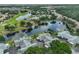 Stunning aerial view of a lakeside community showcasing well-manicured lawns, mature trees, and serene water features at 815 Silverthorn Ln # 0, Sun City Center, FL 33573