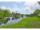 Scenic backyard showcasing a tranquil lake surrounded by lush greenery, creating a serene and picturesque setting at 815 Silverthorn Ln # 0, Sun City Center, FL 33573