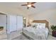 Bedroom featuring a ceiling fan, barn door access to the bathroom, and natural light at 815 Silverthorn Ln # 0, Sun City Center, FL 33573