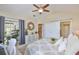 Bedroom features large slider doors to the lanai, neutral walls, and barn door to the bathroom at 815 Silverthorn Ln # 0, Sun City Center, FL 33573