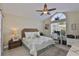 Light-filled bedroom with vaulted ceiling, dedicated desk area, and serene decor, creating a versatile and comfortable space at 815 Silverthorn Ln # 0, Sun City Center, FL 33573