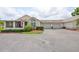 Charming exterior of a home with a two-car garage, well-maintained landscaping, and an American flag at 815 Silverthorn Ln # 0, Sun City Center, FL 33573