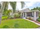 Charming home boasts lush landscaping, mature trees, and a welcoming screened-in porch for relaxing outdoors at 815 Silverthorn Ln # 0, Sun City Center, FL 33573