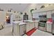 Bright kitchen features stainless steel appliances and breakfast bar at 815 Silverthorn Ln # 0, Sun City Center, FL 33573