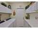 Functional laundry room features white cabinets, white countertops, and front-loading washer and dryer set at 815 Silverthorn Ln # 0, Sun City Center, FL 33573