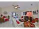 Cozy living room featuring vaulted ceilings, a ceiling fan and sliding door access to patio at 815 Silverthorn Ln # 0, Sun City Center, FL 33573