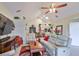 Bright living room boasts a ceiling fan, vaulted ceilings, and access to kitchen at 815 Silverthorn Ln # 0, Sun City Center, FL 33573