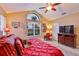 Cozy main bedroom featuring a vaulted ceiling, large window, and neutral walls for a peaceful retreat at 815 Silverthorn Ln # 0, Sun City Center, FL 33573