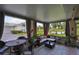 Relaxing screened patio featuring tile floors, comfortable seating, and views of the lush landscape at 815 Silverthorn Ln # 0, Sun City Center, FL 33573