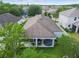 Aerial view of backyard featuring hot tub and covered patio with outdoor furniture at 8228 Sunlit Horizon Ln, Land O Lakes, FL 34637