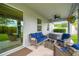 Inviting back porch with comfortable seating, ceiling fan, and a view of the lush backyard at 8228 Sunlit Horizon Ln, Land O Lakes, FL 34637