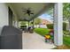 Relaxing back porch with outdoor seating, ceiling fans, and a well-maintained yard perfect for outdoor living at 8228 Sunlit Horizon Ln, Land O Lakes, FL 34637