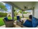 Cozy back porch with a seating area, ceiling fan, and view of the manicured lawn, ideal for enjoying the outdoors at 8228 Sunlit Horizon Ln, Land O Lakes, FL 34637