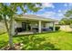 Outdoor living with a covered patio, well-kept lawn, and mature trees providing a serene backyard environment at 8228 Sunlit Horizon Ln, Land O Lakes, FL 34637
