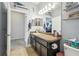 Bright bathroom with granite countertops, dark cabinets, decor on shelves, and nautical-themed wall decorations at 8228 Sunlit Horizon Ln, Land O Lakes, FL 34637