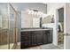 Elegant bathroom featuring a glass-enclosed shower, granite countertop, and sophisticated lighting at 8228 Sunlit Horizon Ln, Land O Lakes, FL 34637