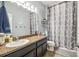 The bathroom showcases a neutral wall, complementing the granite countertop and the sleek design of the dark cabinets at 8228 Sunlit Horizon Ln, Land O Lakes, FL 34637