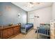 Bedroom boasts a playful design, with brick accents, twin beds, and a ceiling fan for added comfort at 8228 Sunlit Horizon Ln, Land O Lakes, FL 34637