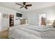 Bright bedroom featuring a tufted headboard bed, soft carpet, and TV at 8228 Sunlit Horizon Ln, Land O Lakes, FL 34637