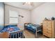 Bright and airy bedroom with twin beds, window, and playful decor creating a cheerful atmosphere at 8228 Sunlit Horizon Ln, Land O Lakes, FL 34637