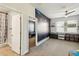 Spacious bedroom with space-themed mural, ceiling fan, and carpet flooring at 8228 Sunlit Horizon Ln, Land O Lakes, FL 34637
