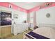 This bedroom showcases a playful design with unique wall art and a cozy atmosphere at 8228 Sunlit Horizon Ln, Land O Lakes, FL 34637