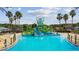 Zero entry community pool featuring a play area with slides for  at 8228 Sunlit Horizon Ln, Land O Lakes, FL 34637