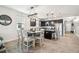 Open dining room area leads into the kitchen with pendant lighting and views of front entry at 8228 Sunlit Horizon Ln, Land O Lakes, FL 34637