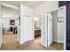 Hallway view of the kitchen, bathroom, and bedroom entrances, each with its own unique design and style at 8228 Sunlit Horizon Ln, Land O Lakes, FL 34637