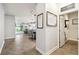 View of a hallway showcasing tile flooring and an open layout with views into the kitchen and living area at 8228 Sunlit Horizon Ln, Land O Lakes, FL 34637