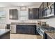 Contemporary kitchen boasts stainless steel appliances, granite countertops, and dark cabinetry at 8228 Sunlit Horizon Ln, Land O Lakes, FL 34637