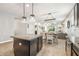Open kitchen flows into the dining area with pendant lighting and a granite island at 8228 Sunlit Horizon Ln, Land O Lakes, FL 34637