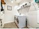 Well-equipped laundry room with modern appliances and ample storage at 8228 Sunlit Horizon Ln, Land O Lakes, FL 34637