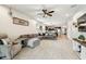 Spacious living area open to the kitchen, featuring a sectional sofa and plenty of natural light at 8228 Sunlit Horizon Ln, Land O Lakes, FL 34637
