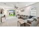 Comfortable living room featuring a large sectional sofa and sliding glass doors to the backyard at 8228 Sunlit Horizon Ln, Land O Lakes, FL 34637