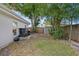 Spacious backyard featuring mature trees, a wooden fence, and ample greenery at 8407 Granite Pl, Tampa, FL 33615