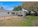 Inviting backyard featuring a stone patio, outdoor seating, a fire pit, and lush landscaping at 8407 Granite Pl, Tampa, FL 33615