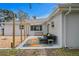 Backyard patio shaded by an awning, with neutral lounge furniture and colorful area rug at 8407 Granite Pl, Tampa, FL 33615