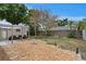 Charming backyard retreat with a stone patio, fire pit, seating, and well-maintained landscaping at 8407 Granite Pl, Tampa, FL 33615