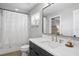 Modern bathroom with a sleek vanity, large mirror, and shower with decorative tile accents at 8407 Granite Pl, Tampa, FL 33615