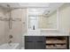 Elegant bathroom featuring a modern sink, granite countertop, and tiled shower with decorative accents at 8407 Granite Pl, Tampa, FL 33615
