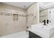 Well-lit bathroom featuring a shower-over-tub setup, granite counters, and a modern vessel sink at 8407 Granite Pl, Tampa, FL 33615