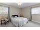 Cozy bedroom featuring two windows, gray accents, and comfortable chairs, perfect for relaxation at 8407 Granite Pl, Tampa, FL 33615
