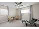Spacious bedroom with comfortable seating, ceiling fan, and ample natural light, perfect for relaxation at 8407 Granite Pl, Tampa, FL 33615