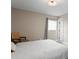 Bright bedroom showcasing neutral tones, a comfortable bed, and ample natural light, creating a serene space at 8407 Granite Pl, Tampa, FL 33615