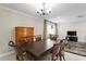 Formal dining room with an elegant light fixture and view to the living area at 8407 Granite Pl, Tampa, FL 33615