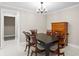Formal dining room featuring a stylish light fixture and a view to a connecting room at 8407 Granite Pl, Tampa, FL 33615