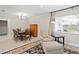 Open dining room with a decorative rug, modern lighting, and view to the backyard at 8407 Granite Pl, Tampa, FL 33615