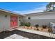 Close-up of a charming home's front entrance with vibrant red double doors and neatly landscaped surroundings at 8407 Granite Pl, Tampa, FL 33615
